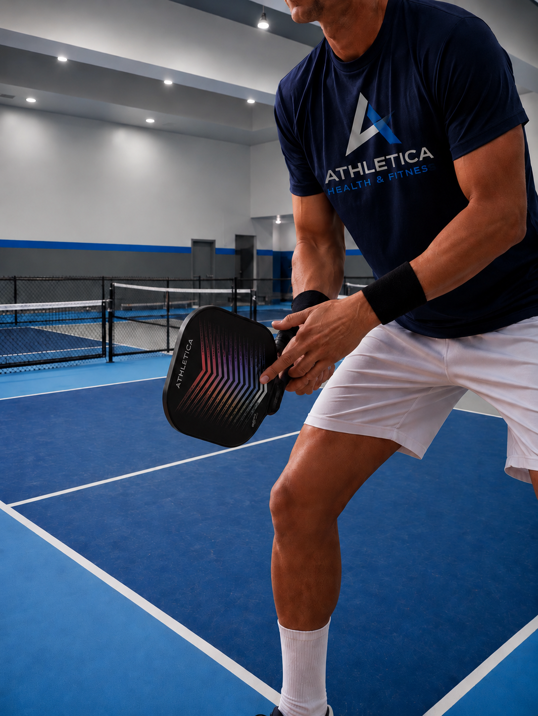 Athletica pickleball player on an indoor pickleball court